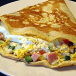 Savor the Classic Galette Complète: Egg, Cheese & Turkey Delight